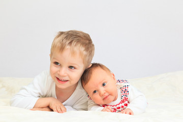 portrait of little boy with newborn sister