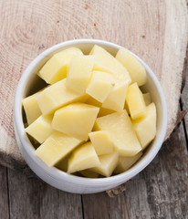 cut raw potatoes in bowl