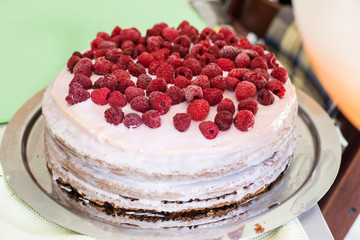 Fresh dessert fruit tart covered in raspberries