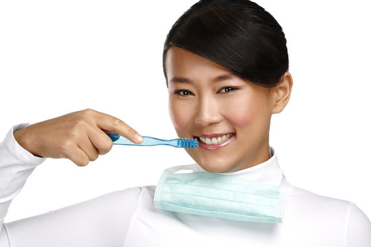 smiling young asian woman dentist showing a toothbrush