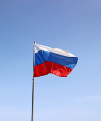 Russian flag waving against a blue sky