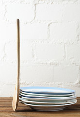 Fototapeta na wymiar retro kitchen utensils wood spoon and old plates in rustic styl