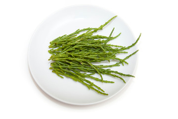 Plate of Samphire isolated on a white studio background.