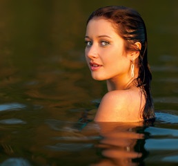 Fototapeta premium Portrait of a beautiful girl in the water