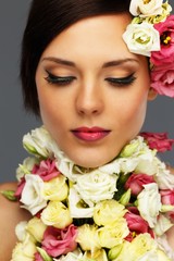 Fototapeta premium Young beautiful brunette woman with flower collar
