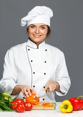 Beautiful young woman cook cutting fresh paprika