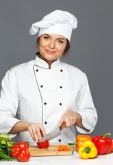 Beautiful young woman cook cutting vegetables