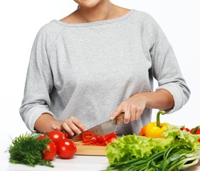 Young woman cooking fresh vegetables