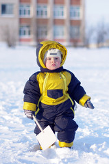 baby with shovel in winter
