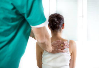 Chiropractor massage the female patient spine and back
