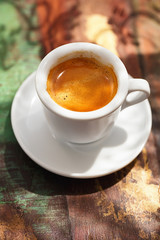 espresso coffee cup on rustic table with sun