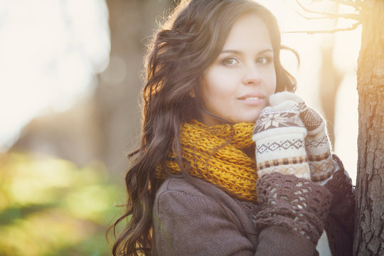Attractive young woman in wintertime outdoor on sunset