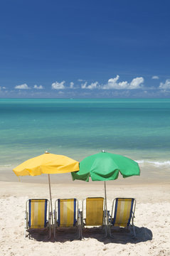 Tropical Beach With Chairs And Umbrellas