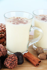 Cups of eggnog with sweets and spices