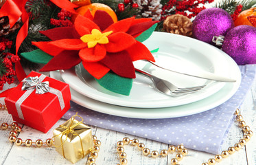 Christmas table setting with festive decorations close up