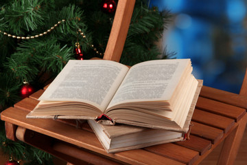 Composition with books on chair on Christmas tree background