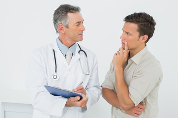 Doctor discussing reports with patient in office