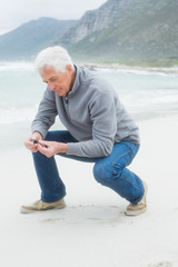 Fototapeta na wymiar Side view of a senior man relaxing at beach