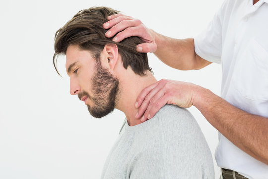 Side view of a man getting the neck adjustment done