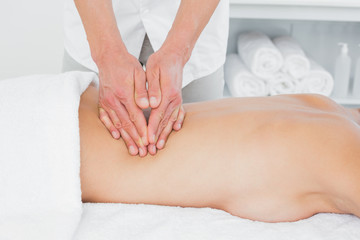 Close-up of a physiotherapist massaging woman's back