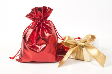 Red bag with gifts and a gold bow