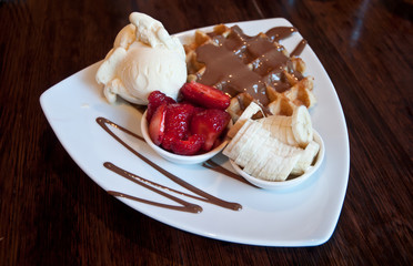Premium chocolate waffle with strawberry and banana topping with