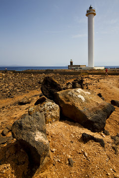 lighthouse and rock in the blue sky   anzarote spain