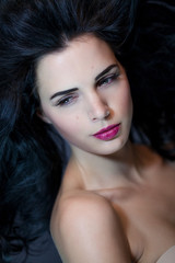 Fototapeta premium junge attraktive frau mit roten lippen und dunklen lockigen haar