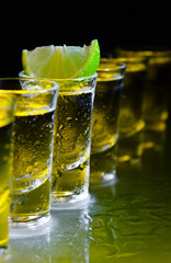tequila and lime on glass table