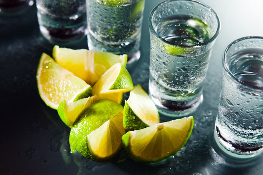 tequila and lime on glass table