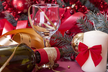 festively decorated glass and a bottle of wine