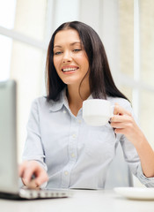 smiling businesswoman or student with laptop