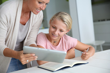 Mother helping girl with homework