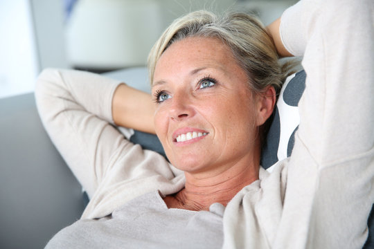 Portrait of mature attractive woman relaxing at home