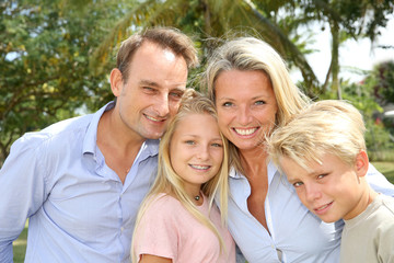 Fototapeta premium Portrait of happy family standing outside