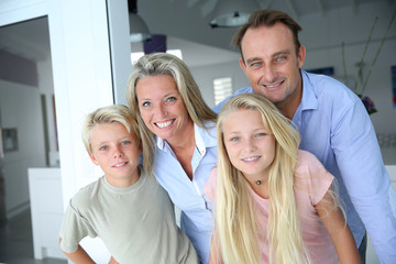 Fototapeta premium Happy family of four looking at camera