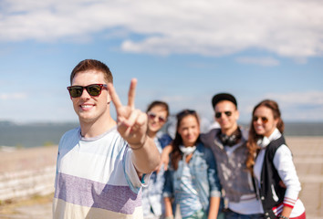 teenage boy with sunglasses and friends outside