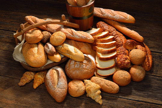 Variety of bread on old wooden background.
