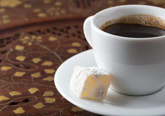 Cup of black turkish coffee on the vintage wooden table.