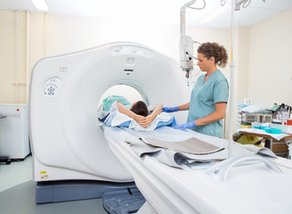 Nurse Preparing Patient For CT Scan