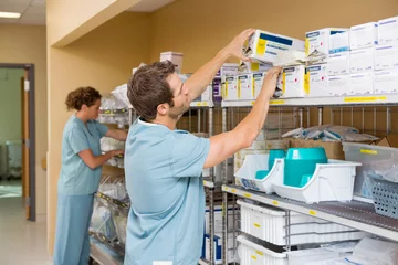 Fotobehang Nurses Arranging Stock In Storage Room © Tyler Olson