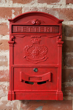 vintage red metal mail box on a brick wall