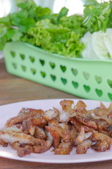 grilled pork on pink dish