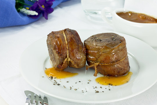 Filet mignon wrapped in bacon with sweet sauce