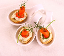 Smoked Lachsrollchen on white bread chunks