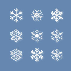 set of white snowflakes on blue background