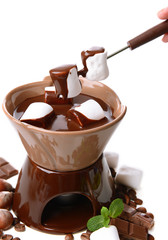 Chocolate fondue with marshmallow candies, isolated on white