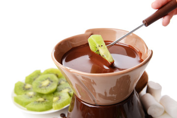Chocolate fondue with fruits, isolated on white