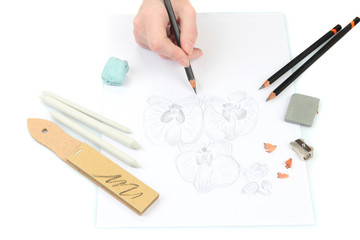 Hand draws a sketch with professional art materials, isolated