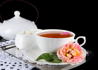 Kettle and cup of tea from tea rose